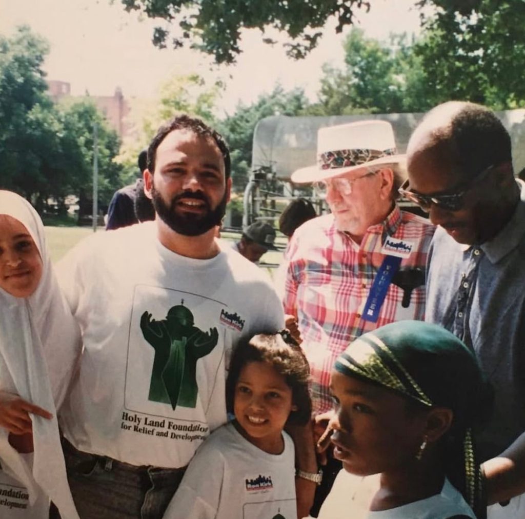 a family poses with their neighbors
